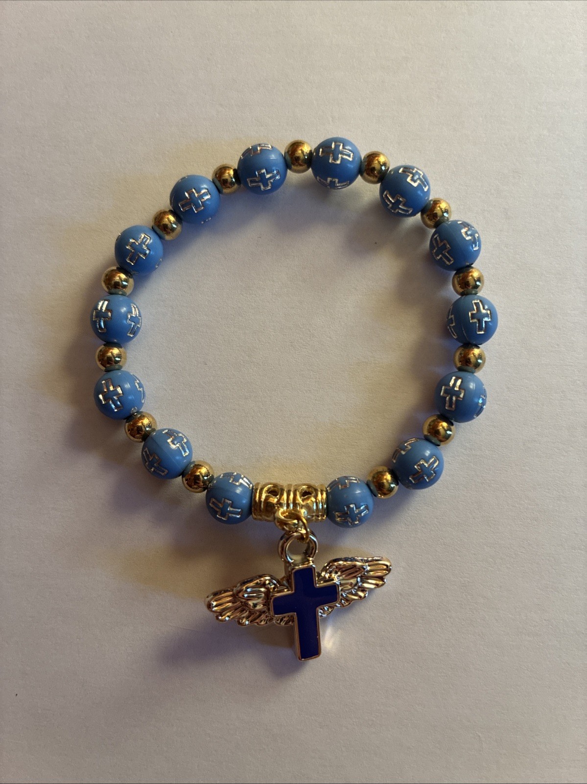 Blue And Gold Beaded Stretch Bracelet With Winged Cross Charm