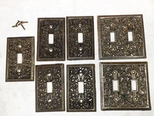 MCM Bronzed Metal Filigree Switch Covers. Lot of Seven