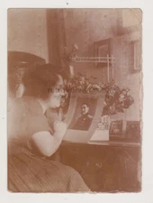 Young Woman Gazes Lovingly at Photo of Her Beloved Soldier on the Table Abstract