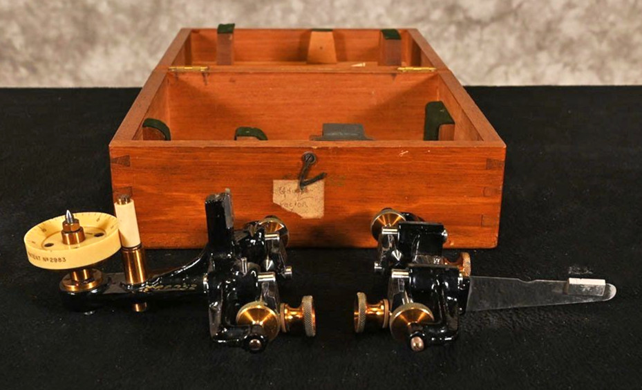 A Cambridge Scientific Instrument Co. manual extensometer — a beautifully machined English precision tool for measuring material strain, looking like jewelry for an engineer's desk.