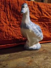 vintage blue and white ceramic duck figurine in the Delft style.
