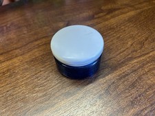 cobalt blue glass cosmetic jar with a white lid