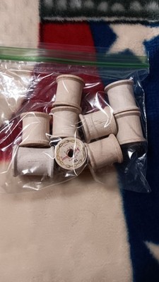 9 small white wooden sewing thread spools