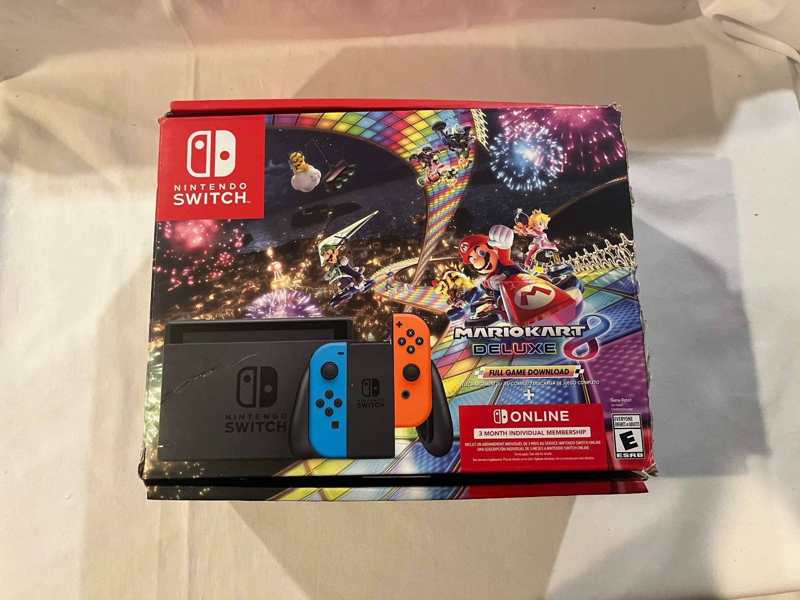 Nintendo Switch with accessories and box with red and blue joy cons
