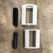 White pedal tractor pedal with black inserts.
