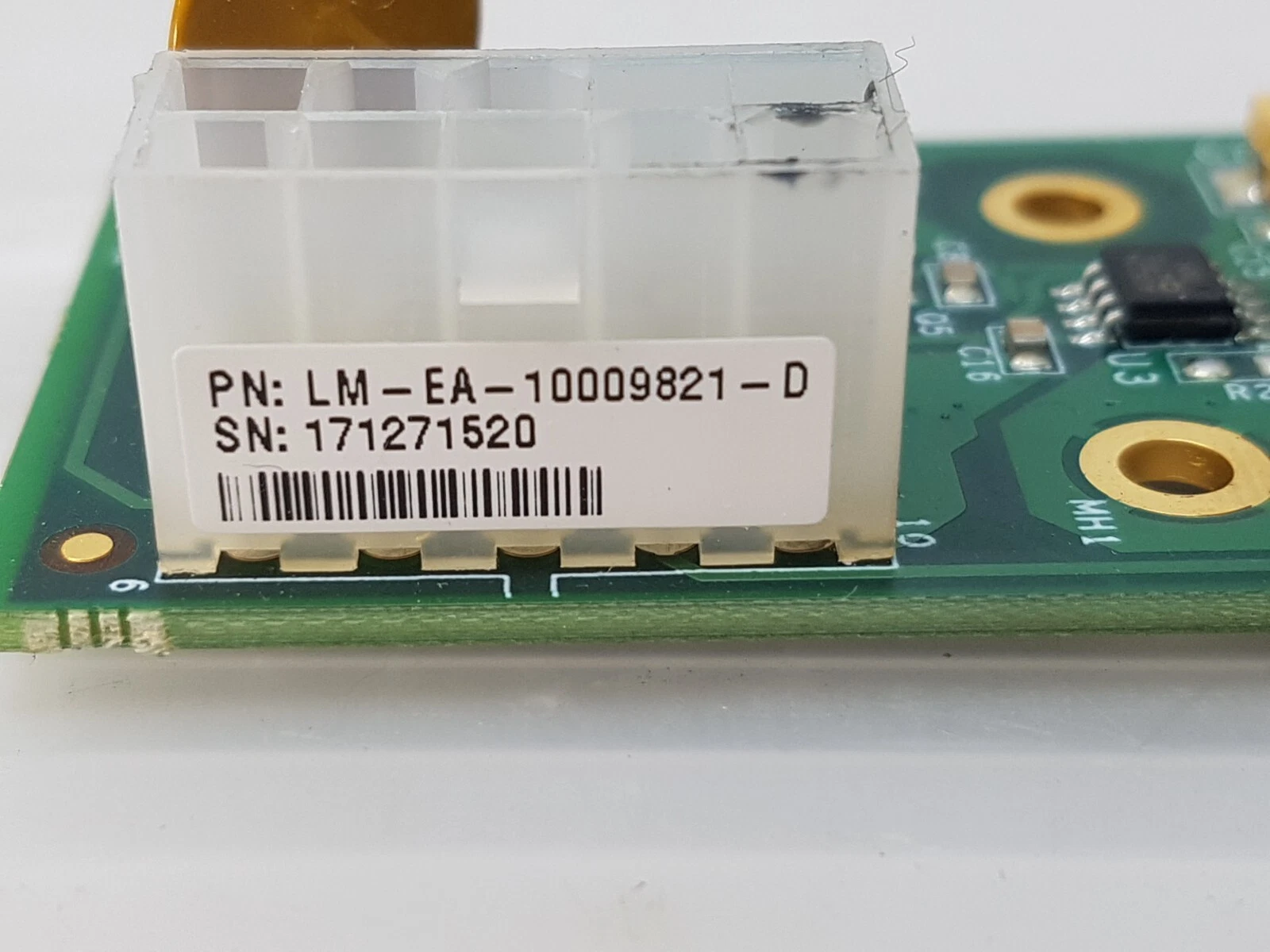 Close-up of the LM-EA-10009821-D label on the white 10-way connector