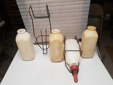 4 Carnaton Calf Bottles, 2 nipples and 2 hangers