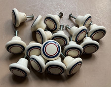 Set of 16 ceramic drawer pulls. Off white w-red blue stripe w-back screws.