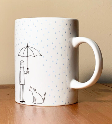 k studio mug cup rain drops dog & person under umbrella bumbershoot while rains