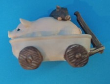 Cute Little Figurine Pink Pig in Wagon with Her Black Piglet Lying Across Back