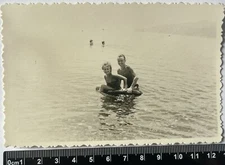 young woman in bikini swimsuit on the beach, shirtless guy, muscles, old photo
