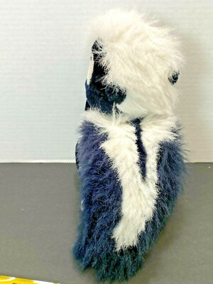 Flower The Skunk Plush Toy - 9 Inch Stuffed Animal Holding Bouquet, Soft & Cute Collectible