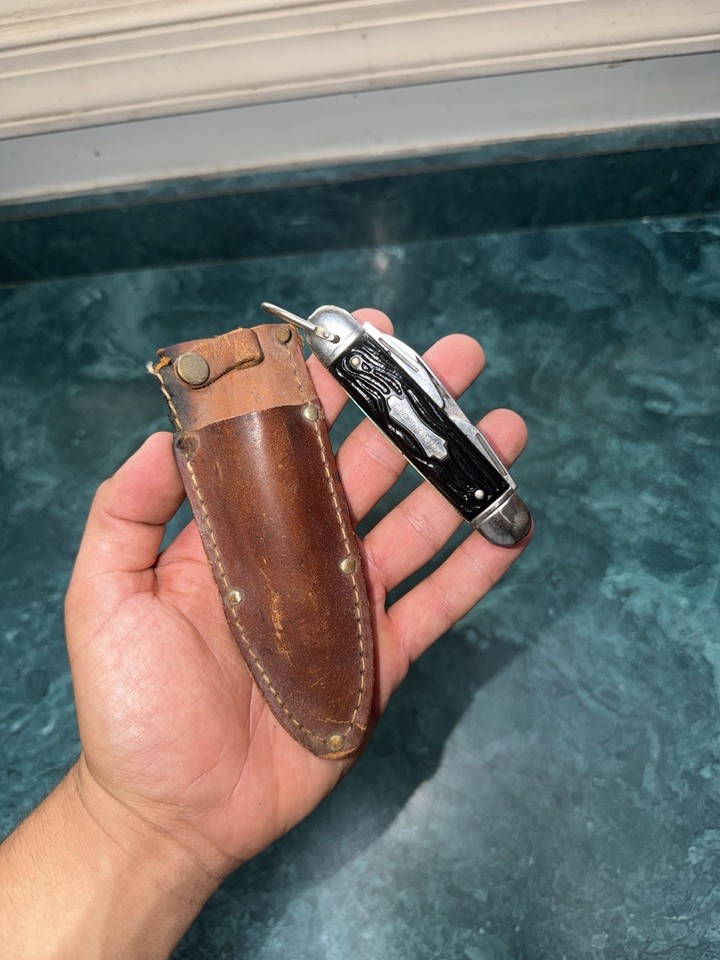 A 1960s Forest Master Colonial multi-tool knife that comes with its original leather holder — complete sets from this era are surprisingly hard to find intact.