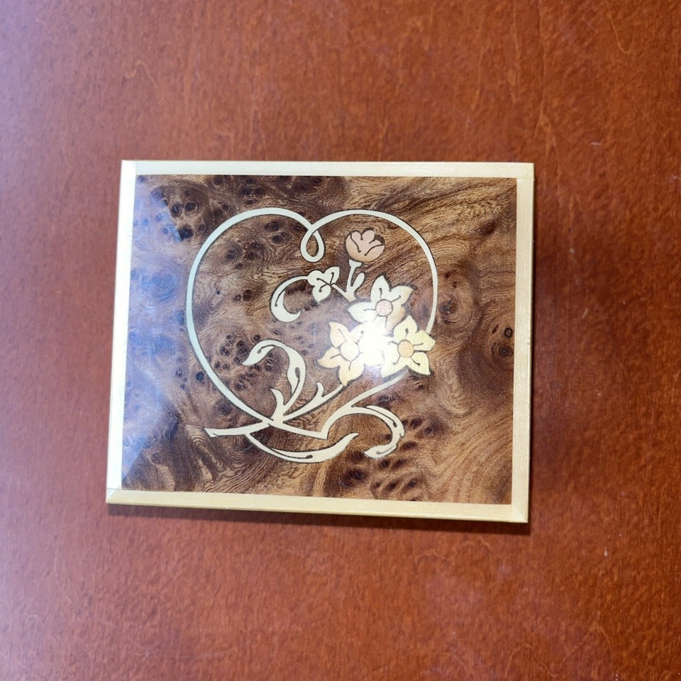 A hand-inlaid Sorrento wood marquetry music box playing Love Story — classic Italian souvenir craft elevated to genuine art object.