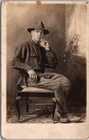PC6046 WW1 Era Military Man Soldier Uniform Chair Studio Scene Postcard RPPC