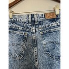 Light blue high-rise vintage Lee jeans size 8 with back pockets, made in USA, on wooden hanger.