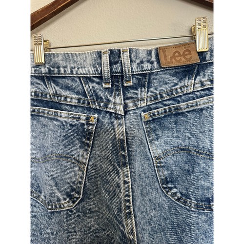 Light blue high-rise vintage Lee jeans size 8 with back pockets, made in USA, on wooden hanger.
