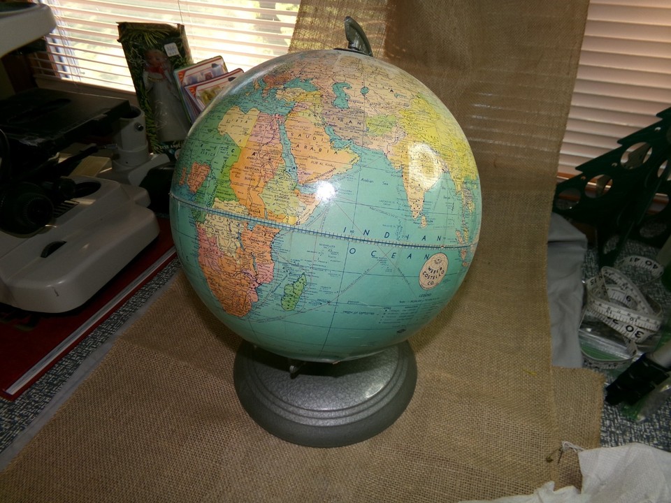 A vintage Weber Costello 10-inch desktop globe with a metal base and built-in time dial — equal parts geography lesson, office statement piece, and time-zone novelty.