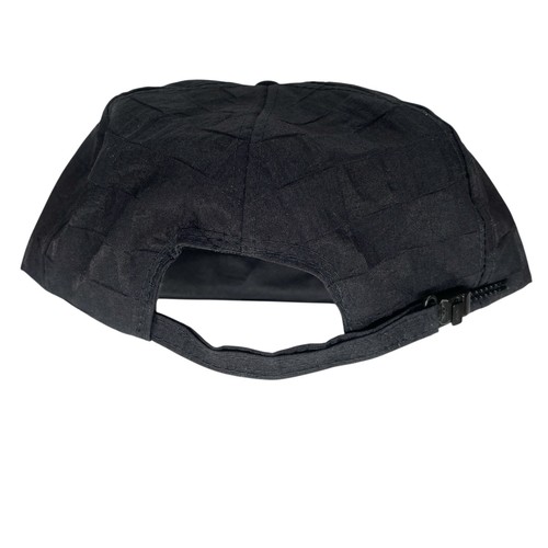 Black snapback patch hat with textured diamond pattern, front zipper, and dark rope detail on the side.