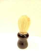 older shaving brush with a black wooden handle