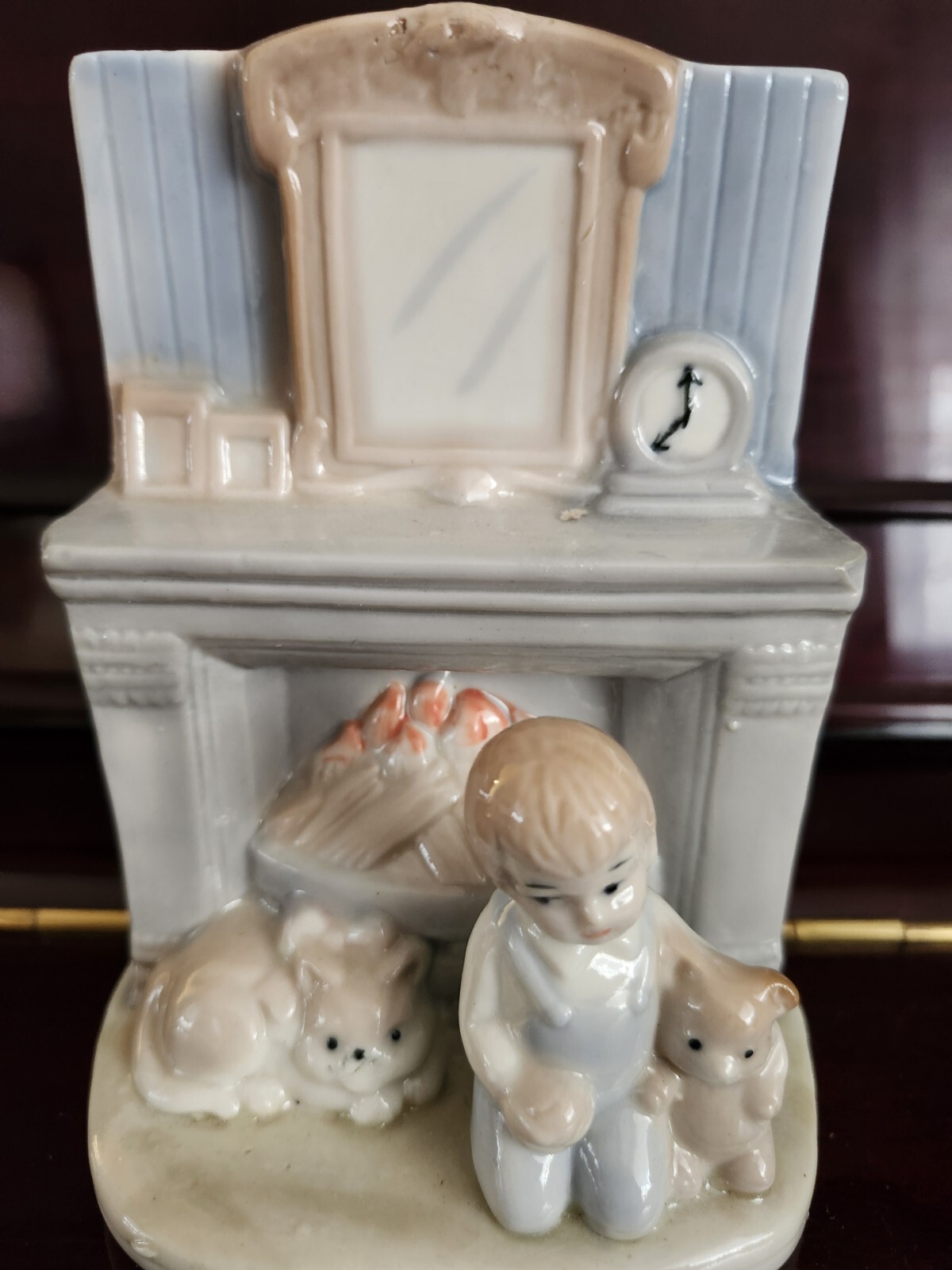 Charming Porcelain Boy Holding Teddy Bear Sitting by Warm Fireplace