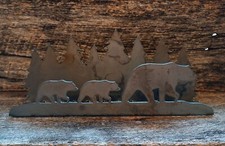Metal cutout of bear with trees