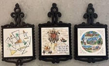 VINTAGE LOT OF 3 CAST IRON TRIVETS with ceramic inserts.