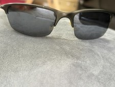 Oakley Wiretap sunglasses feature a pewter frame and dark grey Lens