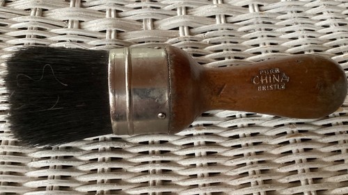 Vintage Osborn #8 brush with brown handle, black bristles, and “Pure China Bristle” lettering on woven background.