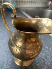 a brass jug with etching on bulbous belly and handles 5.5'' tall and heavy hand