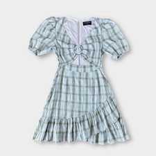 Green check puff sleeve mini dress with front cut-out and ring detail.
