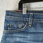 Blue stretch denim shorts with cuffed low rise, front button closure, and side pockets, size 32, USA made.