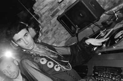 Portrait of DJ Larry Tee behind the turntables at the Love Machine - Old Photo 1