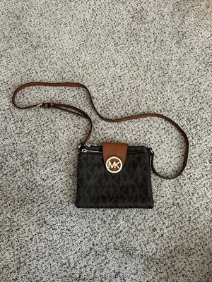 Chic crossbody bag by Michael Kors. Features iconic MK pattern.