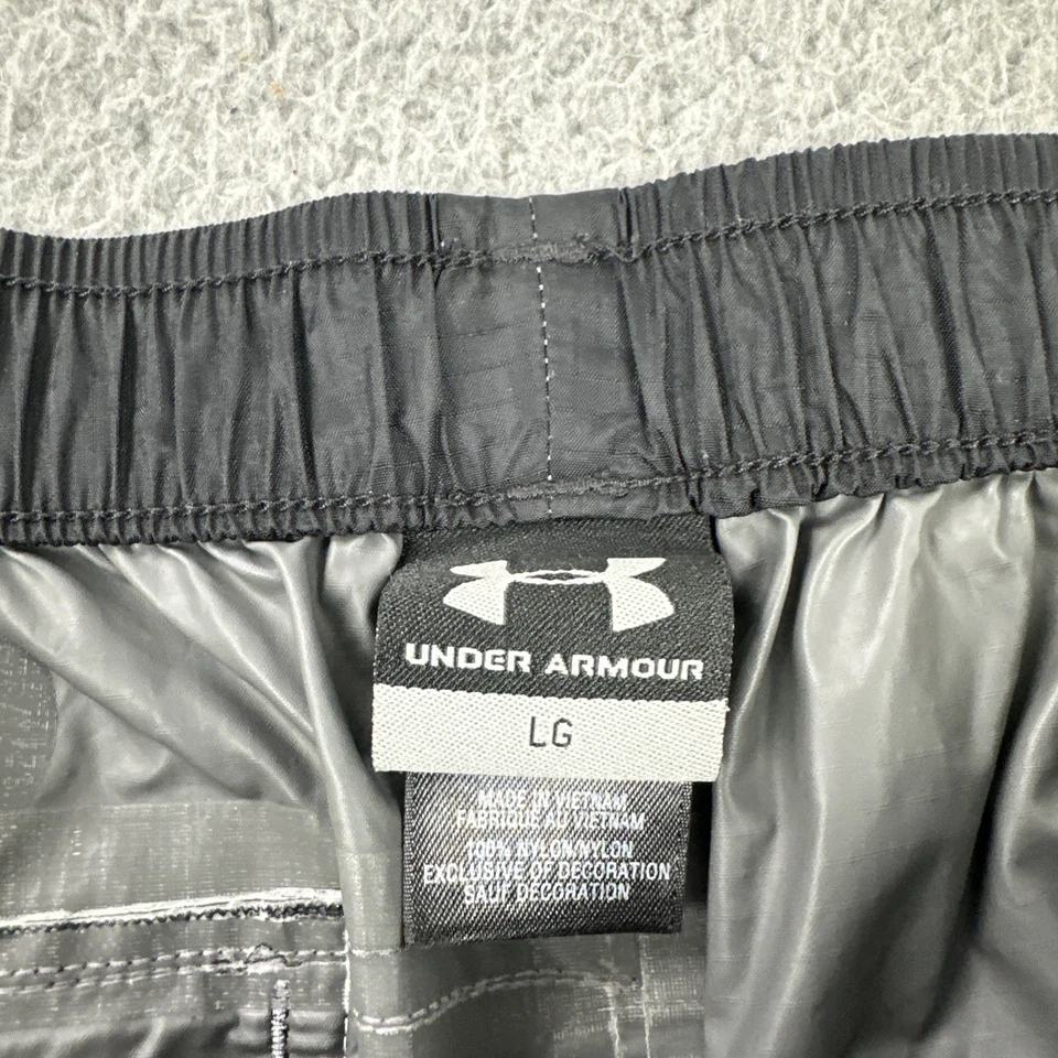 Pantalones deportivos Under Armour de nailon cortavientos para hombre grandes negros con cremallera al tobillo ligeros Foto 2 de 4