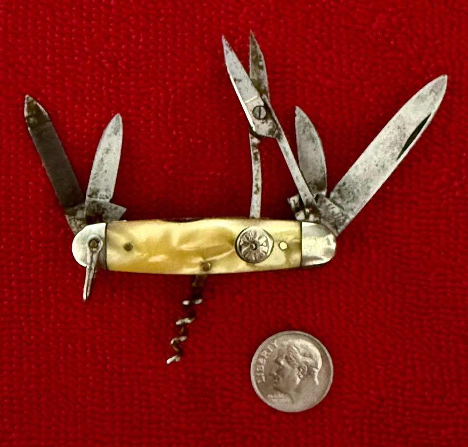 A German-made MELLA-BRAND multi-tool with scissors AND a corkscrew in a tiny package — the kind of finely-crafted Old World pocket tool that predates Leatherman by decades.
