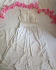 Women's gorgeous white lace dress with low hem for a special occasion or wedding