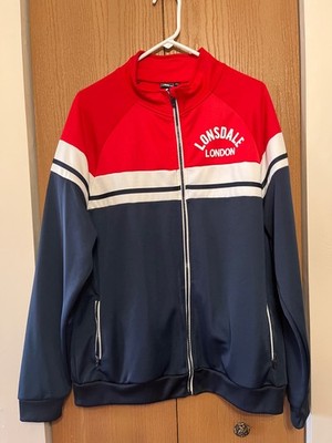 Lonsdale London track jacket features a bold red, white, and navy color-blocked