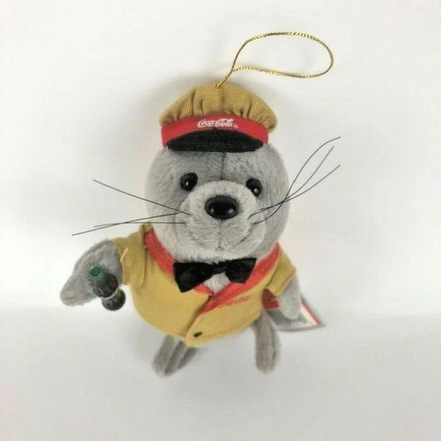 Sello de peluche Coca Cola en uniforme de entrega adorno navideño Foto 2 de 4