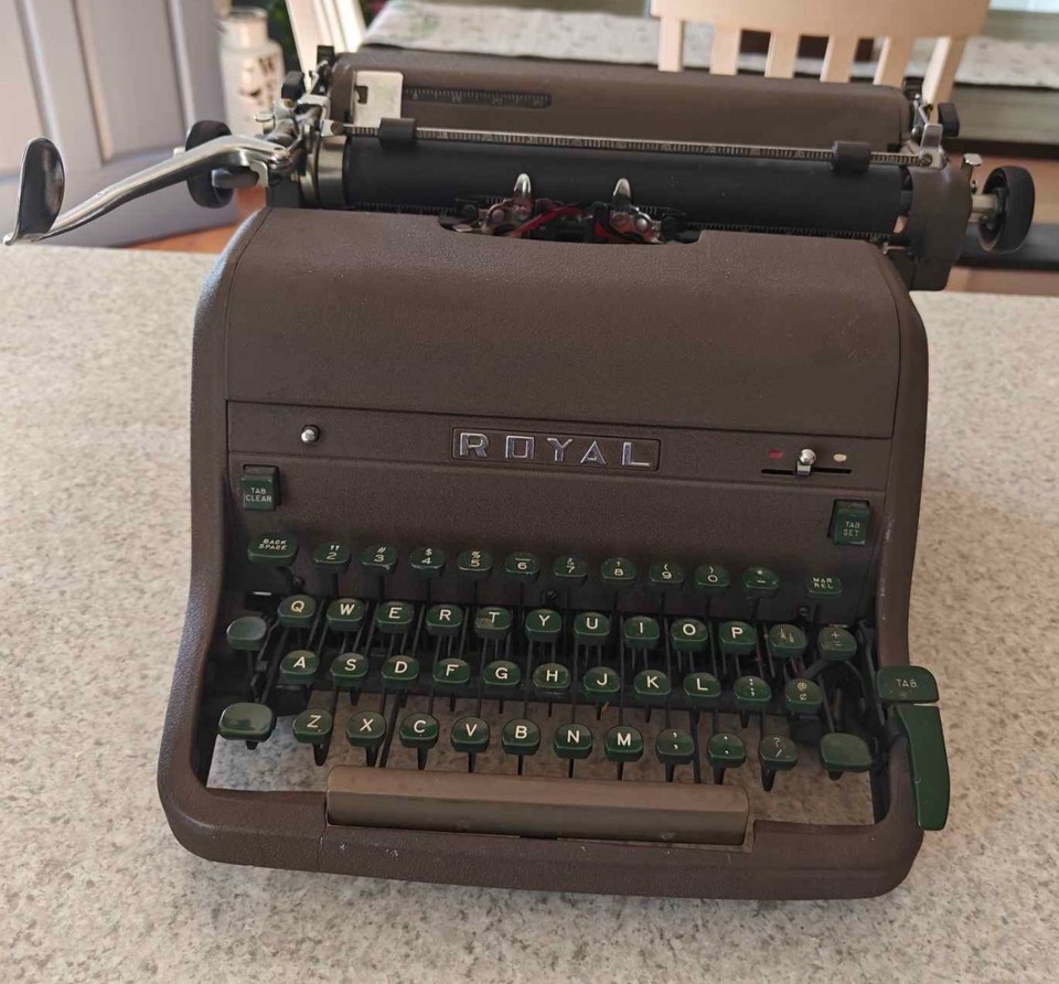 A genuinely working mid-century Royal portable with those gorgeous green keys — ready to clack out your first novel today.