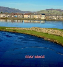 PHOTO  CAERPHILLY CASTLE . LOOKING NORTH ACROSS THE FROZEN MOAT AND THE LAKE BEY