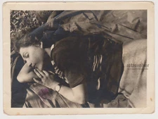 Beautiful Young Woman Asleep on a Coat in Nature Unaware of the Secret Capture