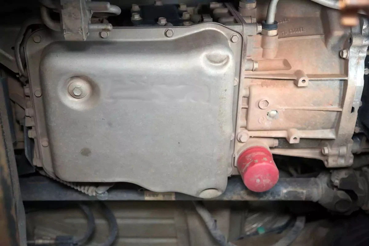 Automatic transmission drain pan and fluid filter on a heavy-duty truck.