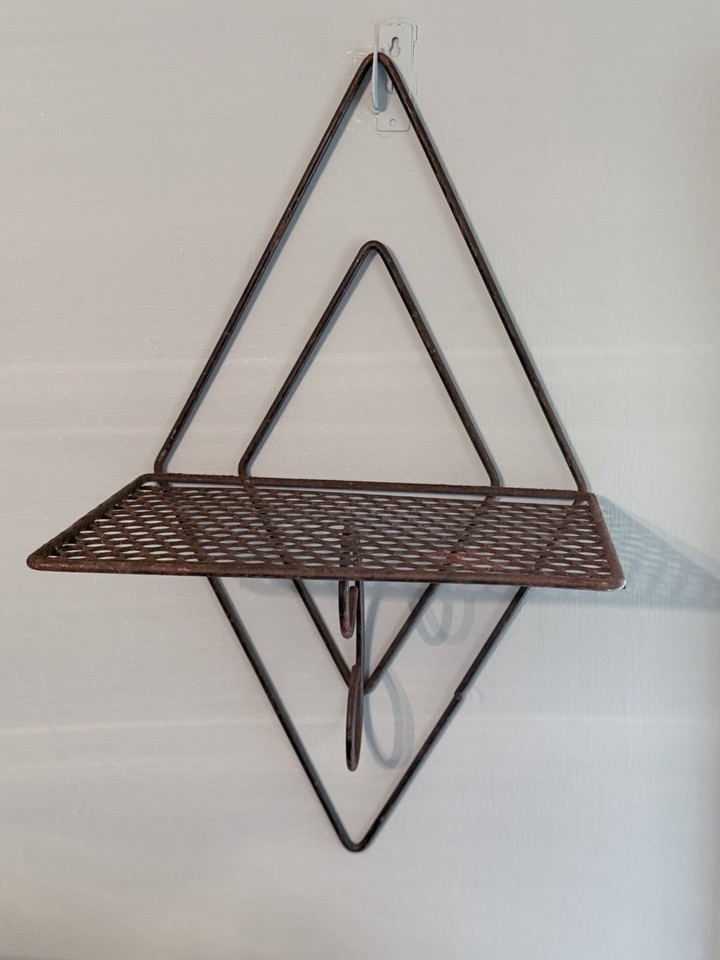A Mid-Century Modern atomic metal wall art piece that doubles as a mesh display shelf — two-in-one Sputnik-era sculptural function that's genuinely hard to find.