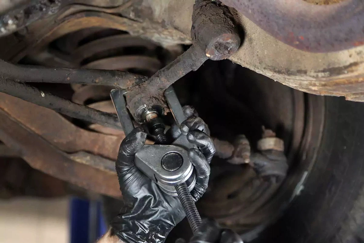 A puller tool separates the idler arm from the center link.