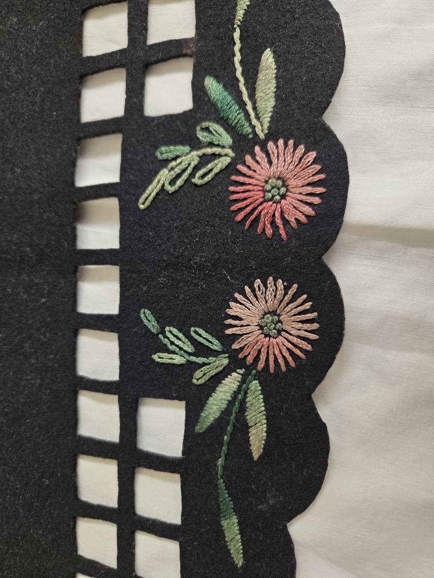 Vtg. black felt table runner w/stitched floral designs and cutout areas.