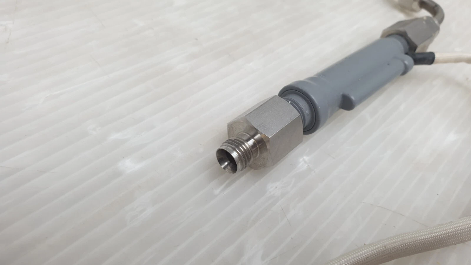 Stainless male fitting on the grey plastic body of the Dwyer P2-15