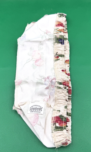 Longaberger fabric liner only with multicolor floral pattern, white label reading “ROW YOUR BOAT” in red text.