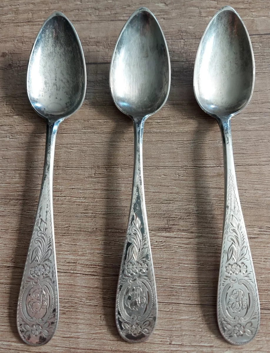 Ornate Silver Teaspoons, Four Spoons with Floral Handles, Arranged in a  Fan-like Manner and Connected