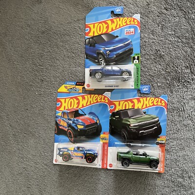   (3) Hot Wheels Silverado EV RST, Baja Truck, And GMC Hummer EV $12  